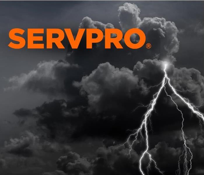 Storm clouds and lightening with servpro logo 